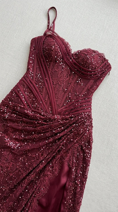 Close-up of bodice and sequin detail on burgundy evening gown