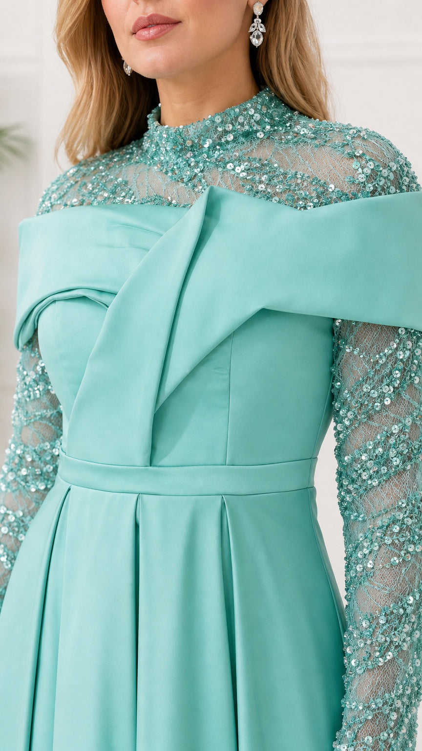 Close-up of sequin neckline and structured drape on mint dress