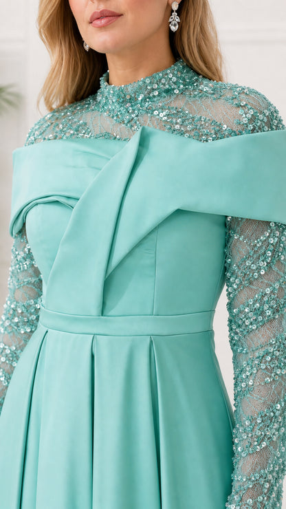 Close-up of sequin neckline and structured drape on mint dress