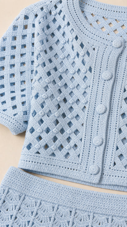 Close up of light blue open knit cardigan texture and buttons