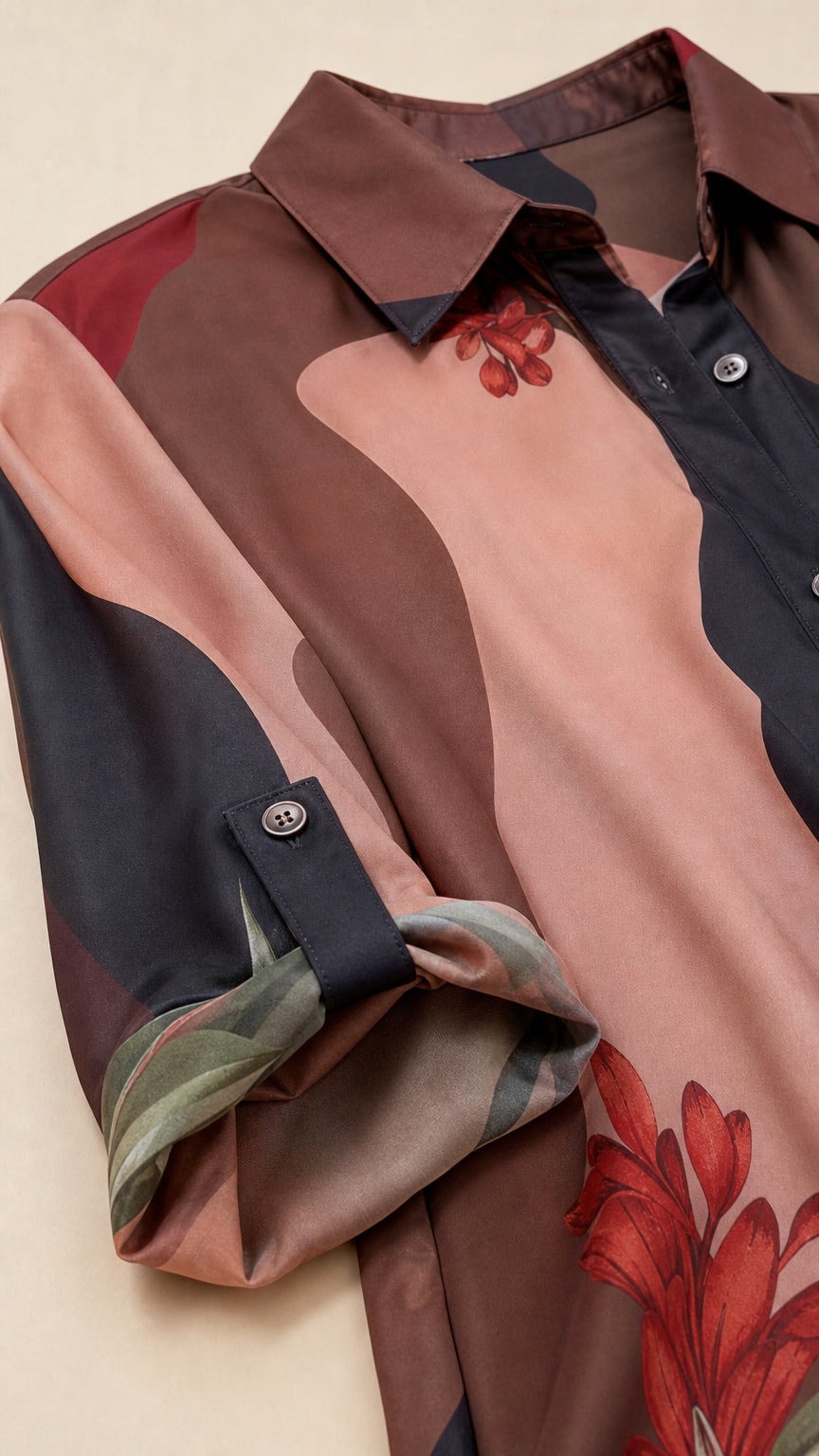 Close-up of collar, button placket, and rolled-tab sleeve detail