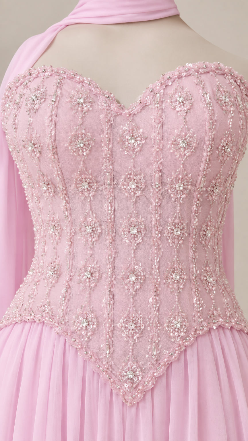Close-up detail of sweetheart neckline and intricate beadwork on pink bodice