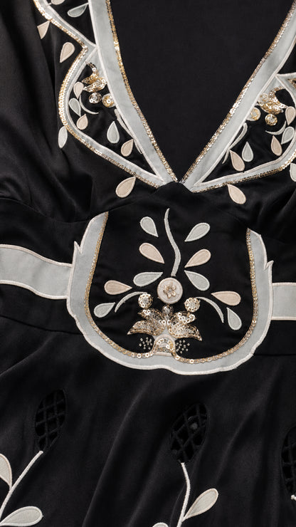 Close-up detail of neckline embroidery and beadwork
