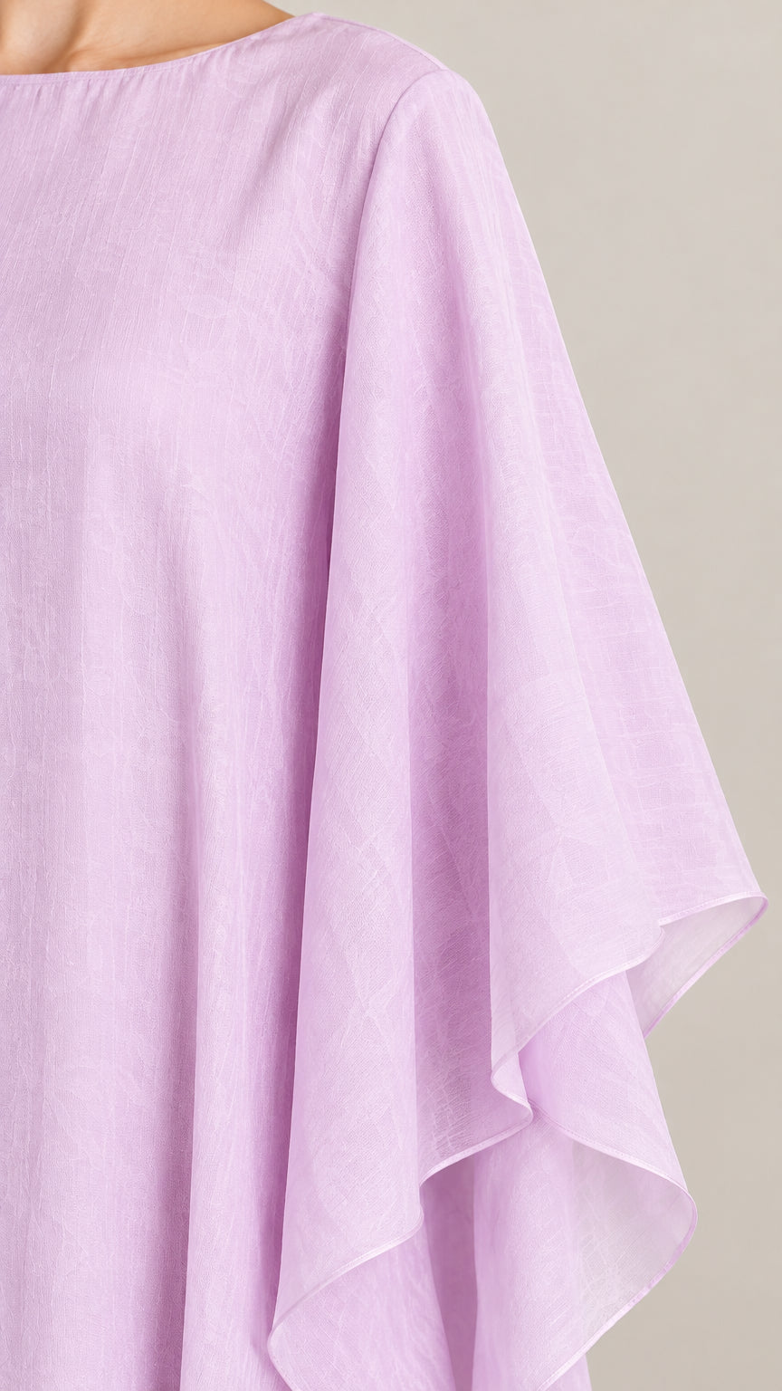 Fabric and neckline detail of light purple textured kaftan dress