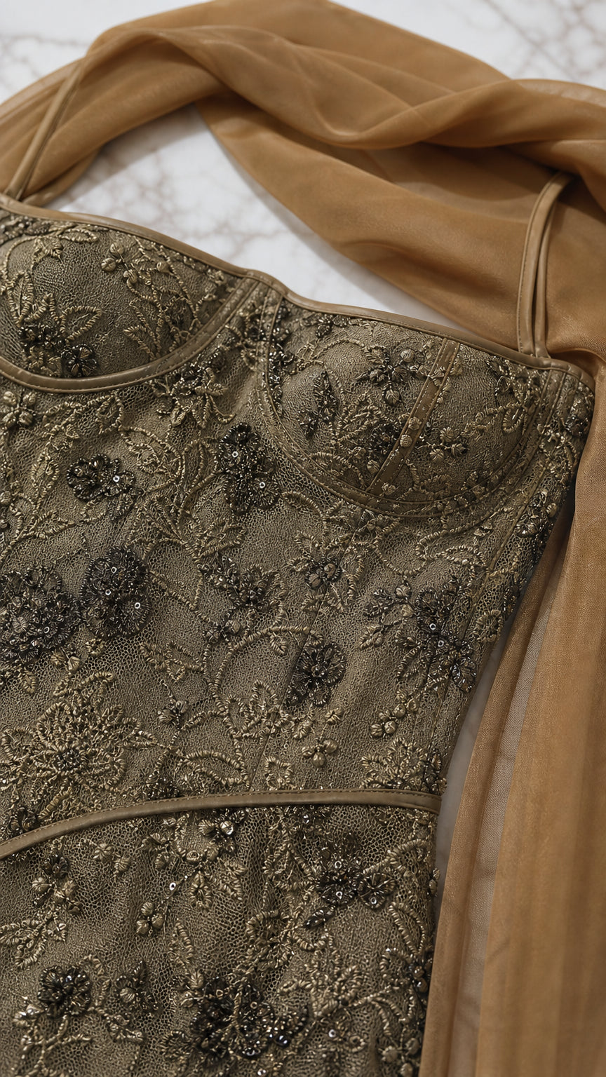 Close-up detail of bodice embroidery and straps