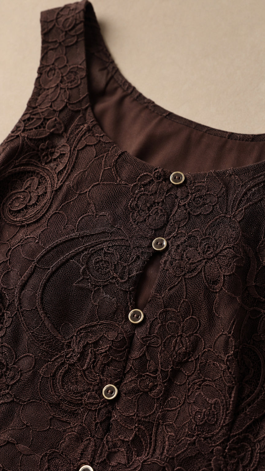 Close-up detail of dark brown lace fabric and front buttons