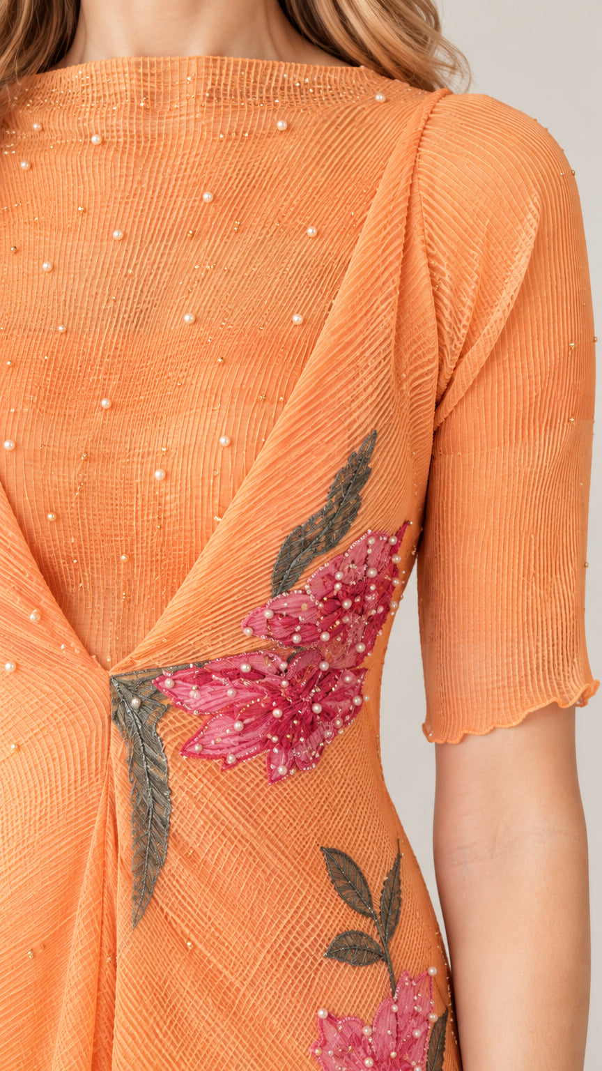Close-up detail of pleated bodice with pearl beading and pink floral embroidery