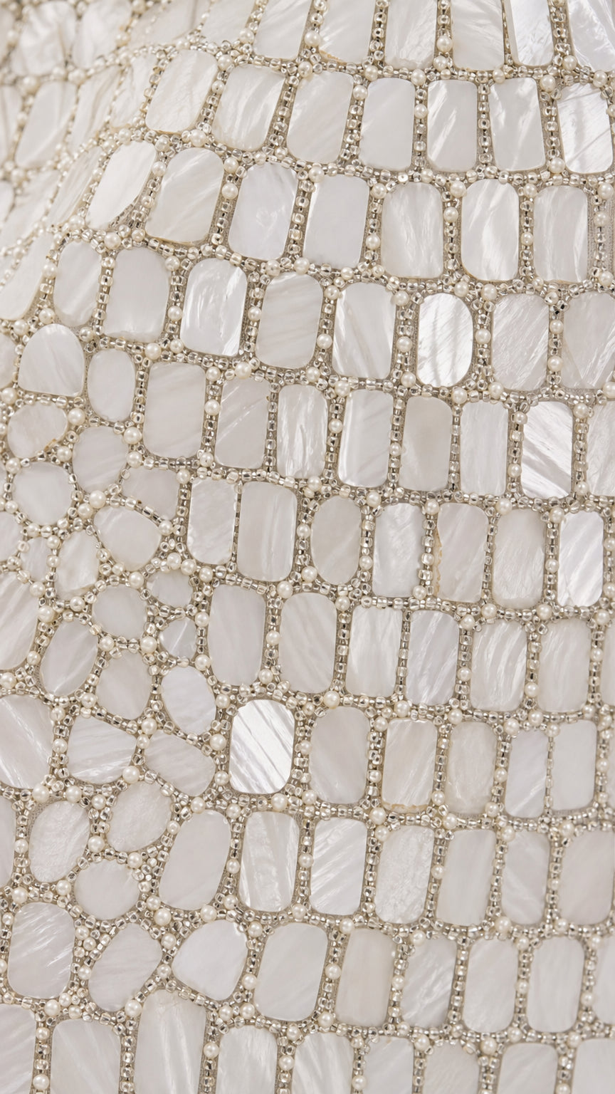 Close-up detail of geometric mosaic beading and texture