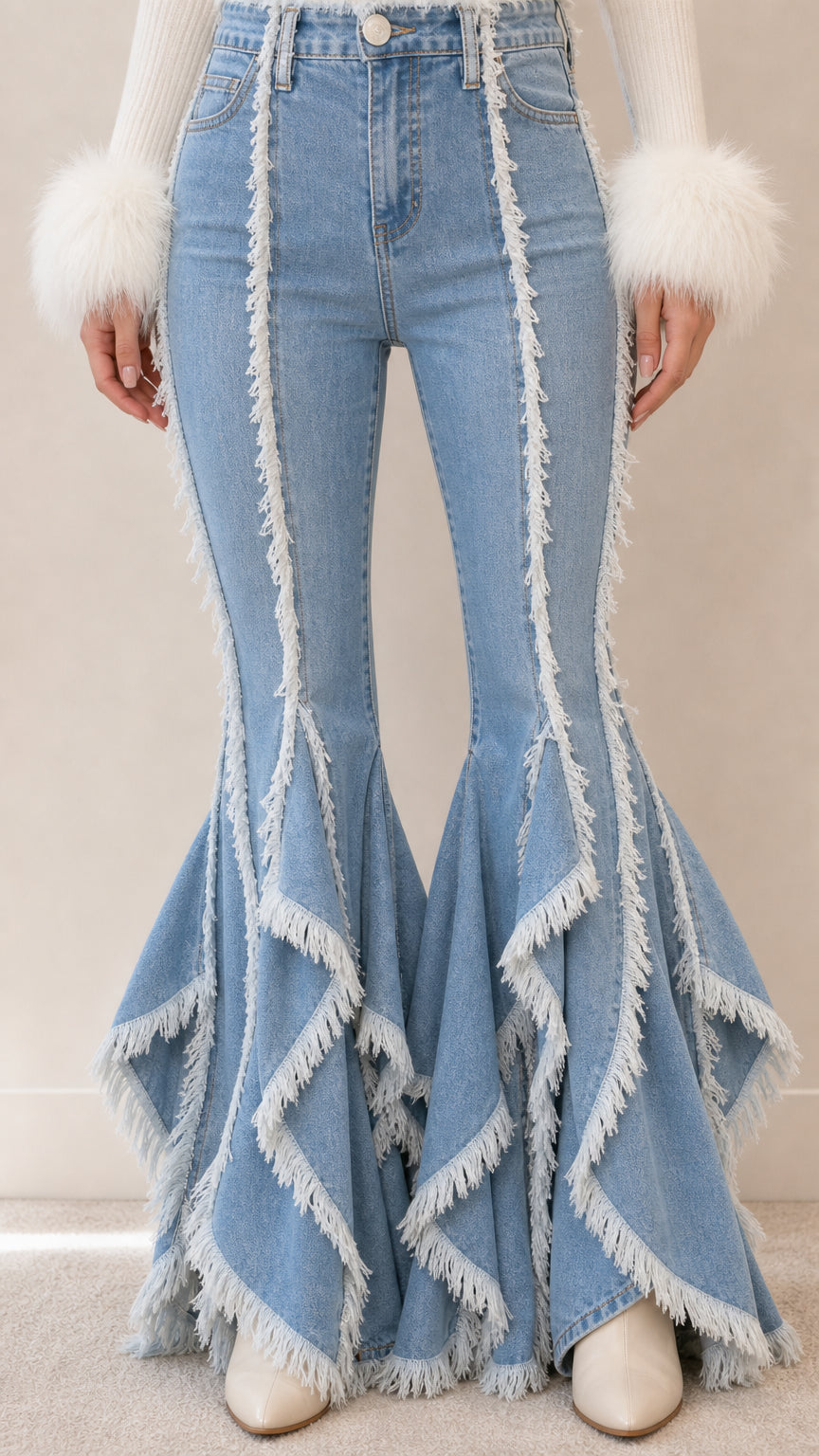 Close-up detail of light blue high-rise waist and tiered fringe flared hems