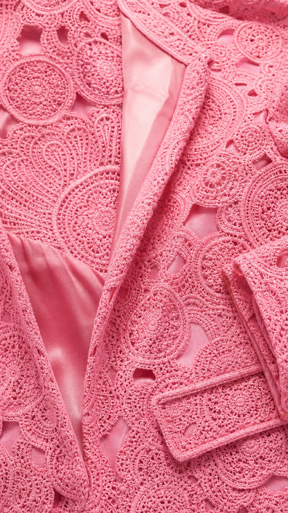Close-up detail of pink textured lace fabric and satin lining