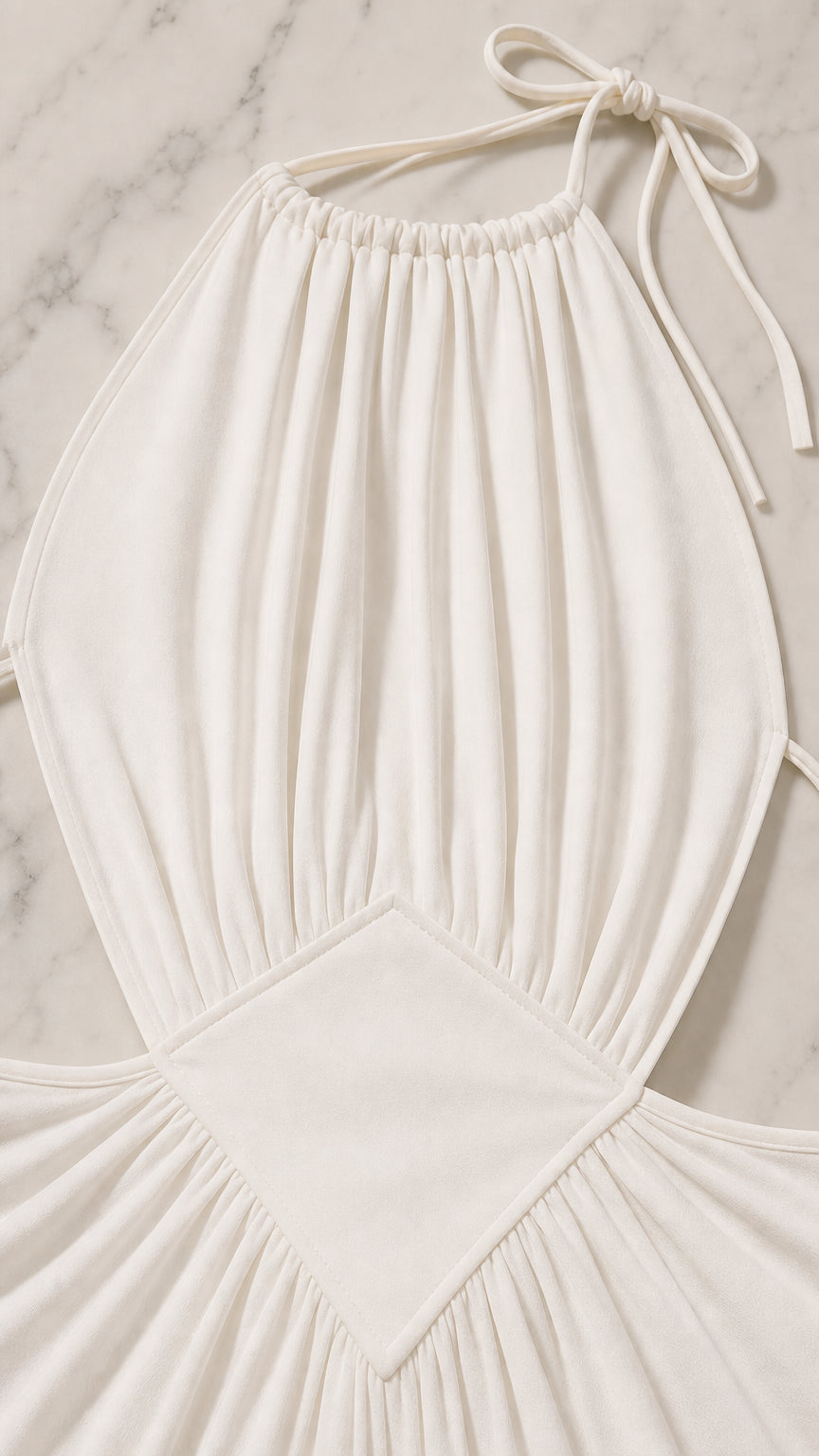 Close-up detail of the gathered bodice and waist cutout on the white dress