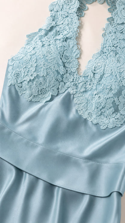 Close up view of intricate floral lace bodice and smooth blue satin fabric