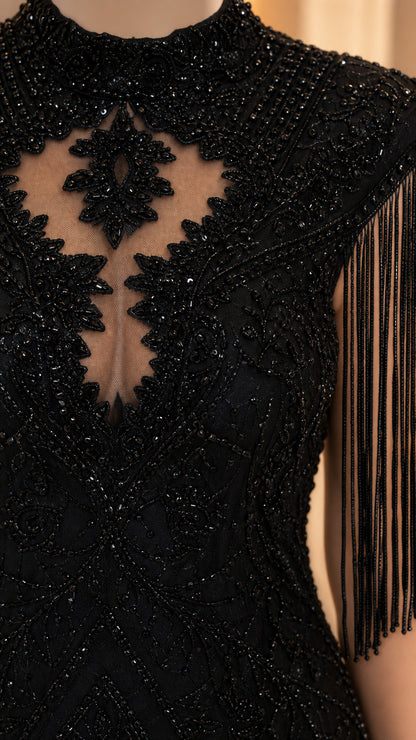 Close-up detail of mock neck, beadwork, and fringe