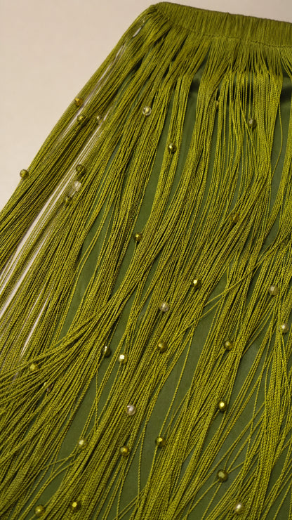 Close-up detail of olive green fringe and bead embellishments