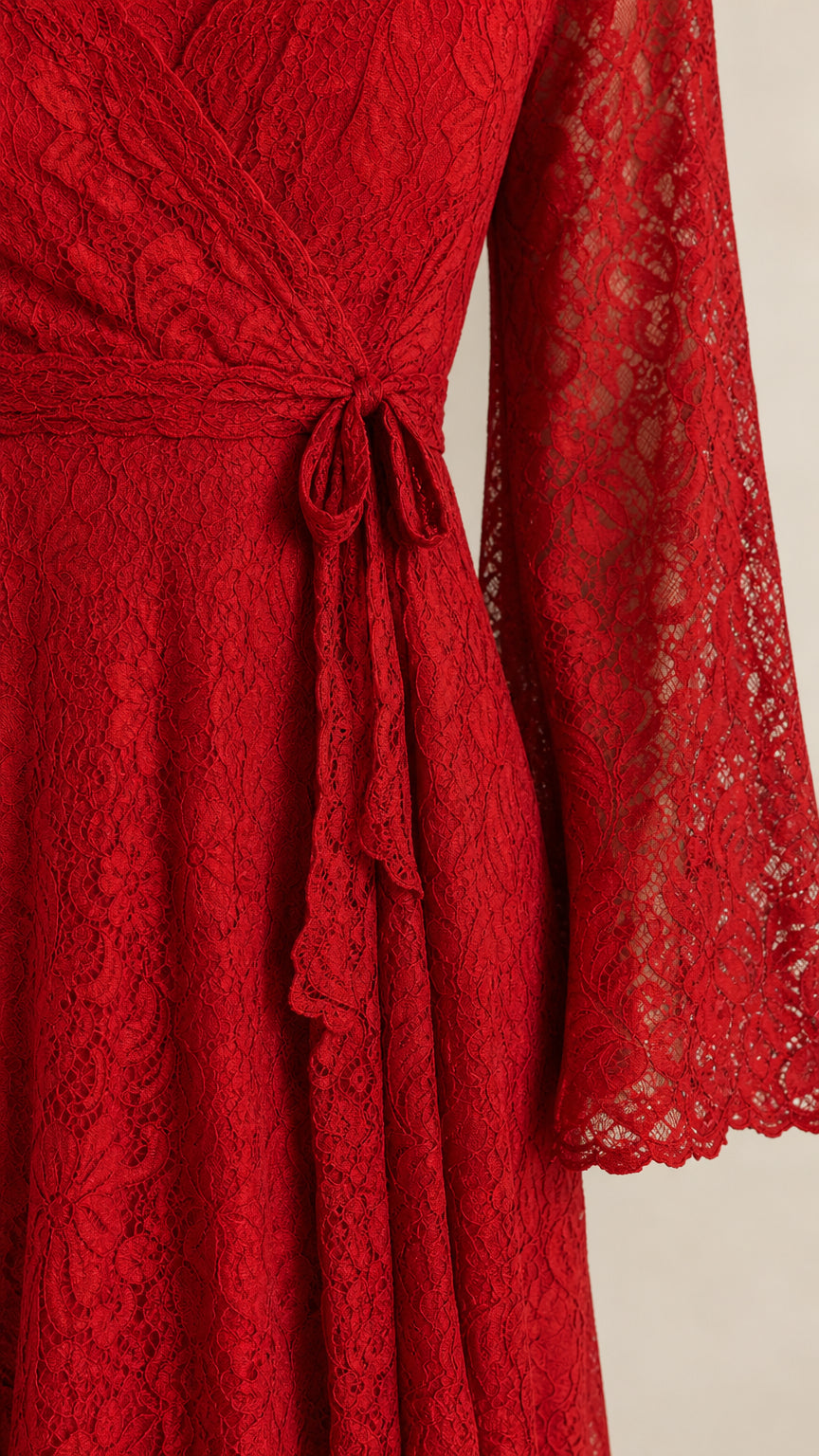 Close-up detail of red floral lace pattern and waist tie sash