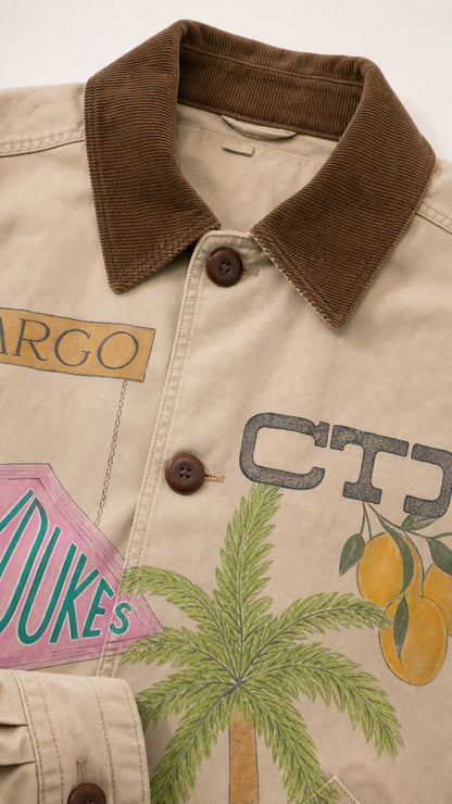 Close-up detail of corduroy collar and button placket on beige graphic barn jacket