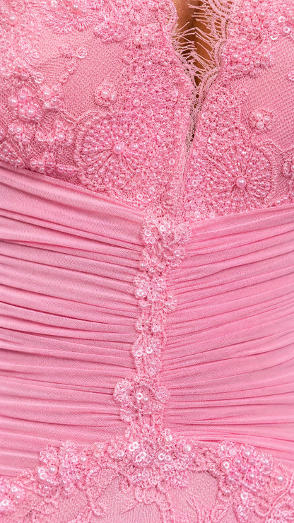 Close-up detail of lace texture and ruched bodice on pink dress
