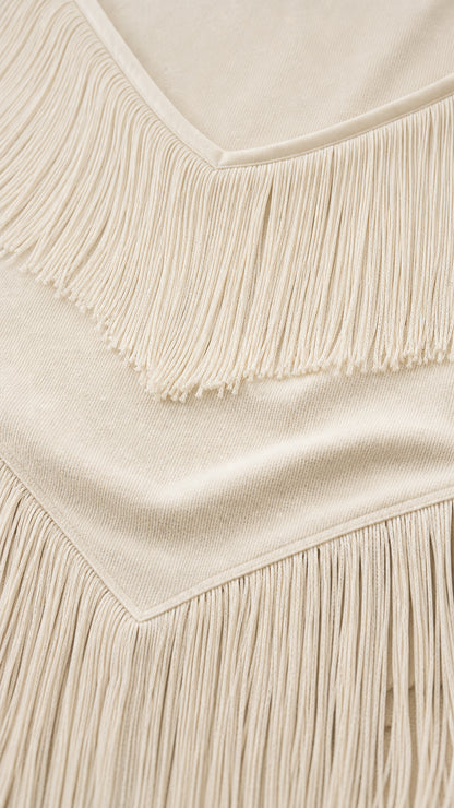 Close-up detail of knitted fabric and delicate fringe trim on bodice