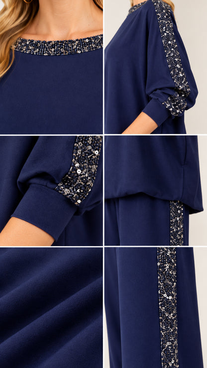 Close-up details of sequin trim on boatneck collar, sleeves, and pant seams