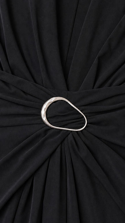 Close-up detail of metal ring waist accent on black dress