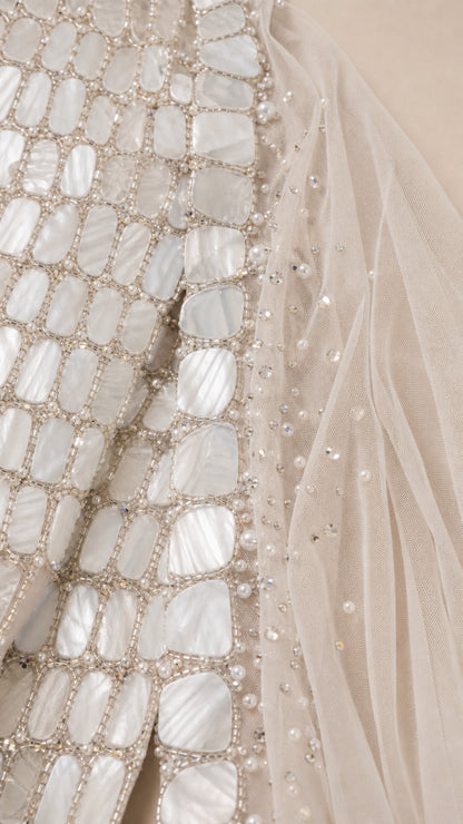 Close-up detail of geometric beadwork and paillette embellishment