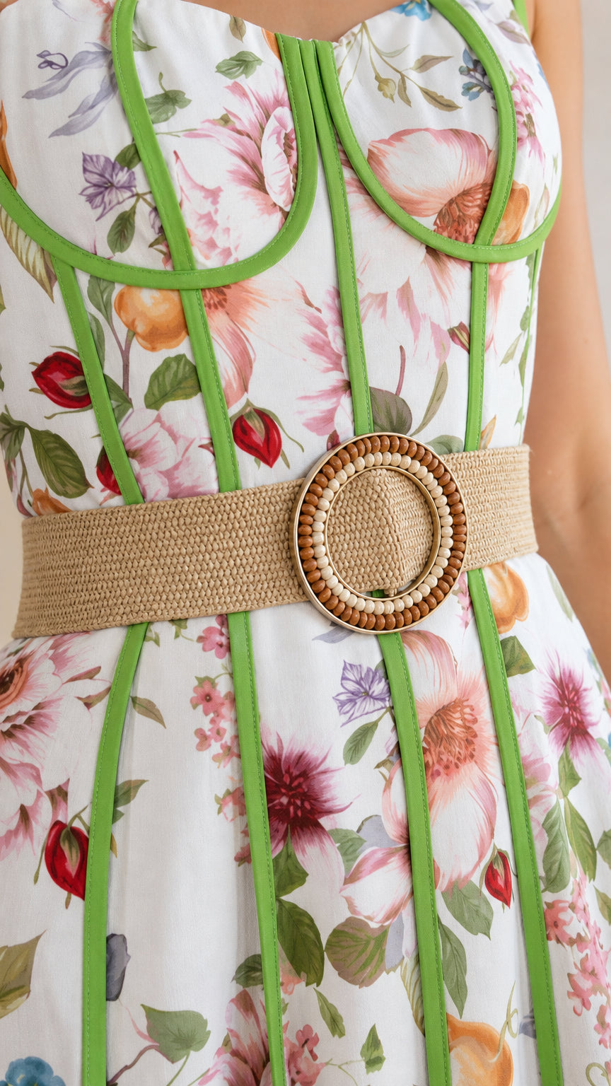 Close up of bodice and woven belt details on white floral dress