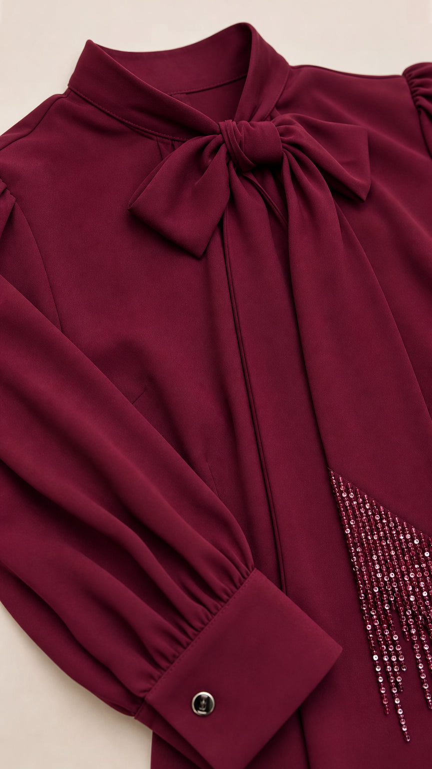 Close-up of bow neckline and rhinestone detailing