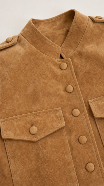 Close-up detail of camel faux suede jacket showing stand collar, epaulets, and covered buttons