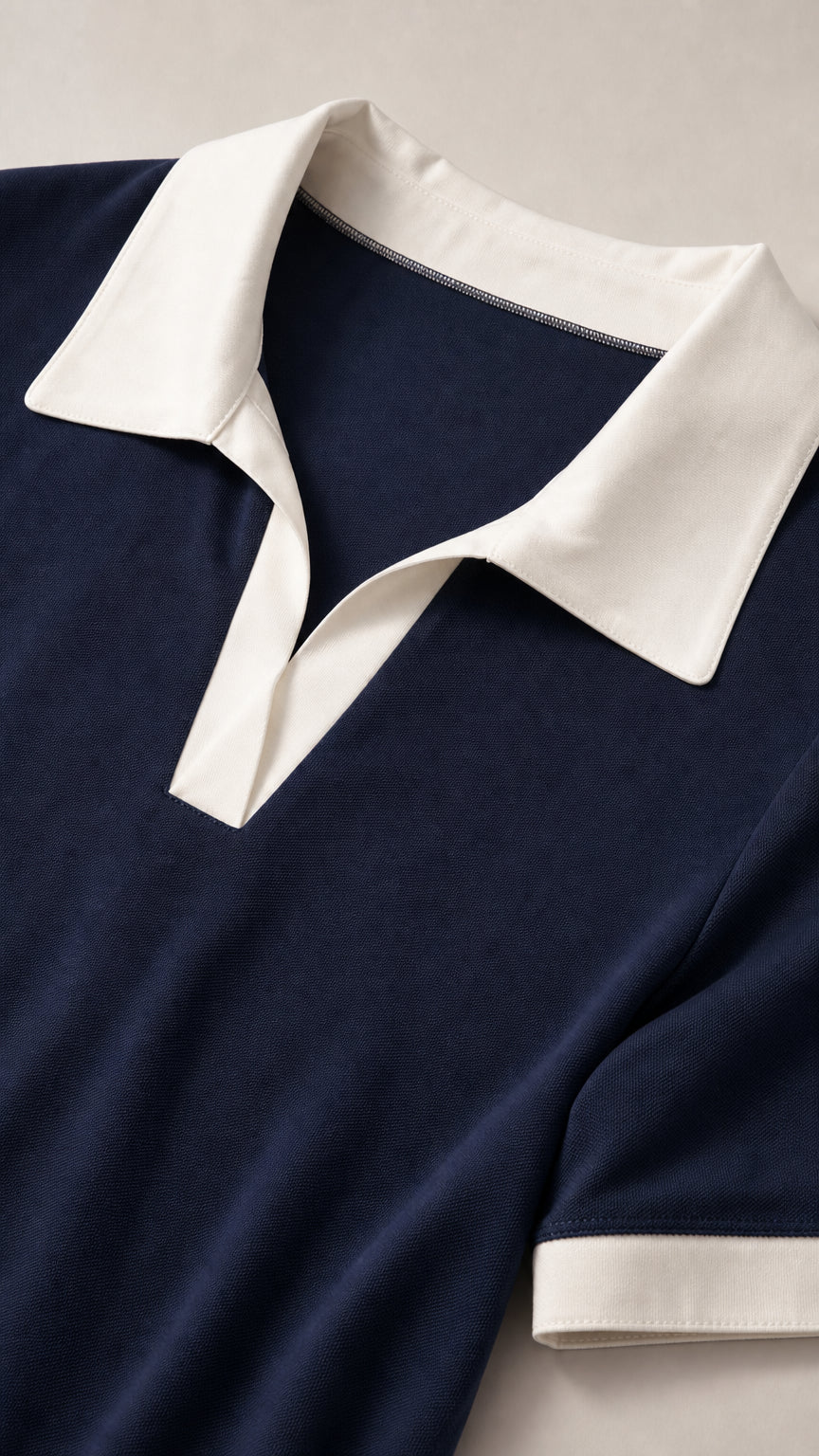 Close-up detail of white contrast polo collar and soft jersey knit fabric