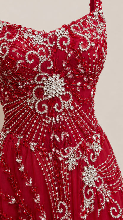 Close-up detail of intricate crystal beadwork and rhinestone embroidery on Ruby Red gown