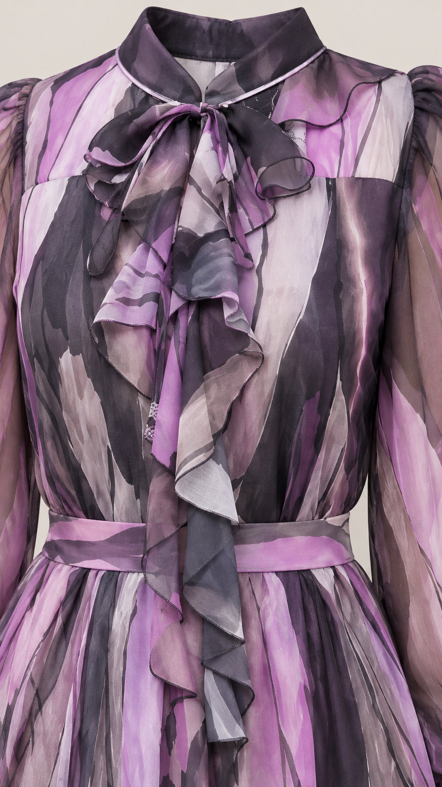 Close-up detail of ruffled neckline and bow tie on purple chiffon dress