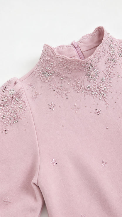 Close-up detail of the mock neck, shoulder embroidery, and beadwork