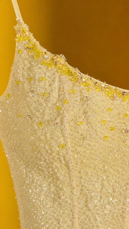Close-up detail of yellow sequin and bead embellishments