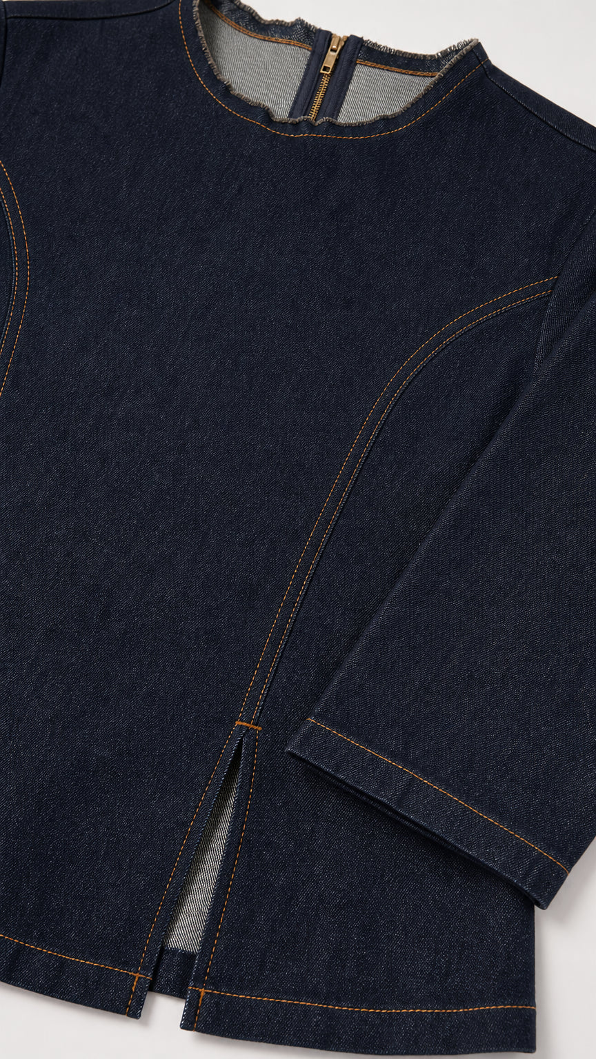 Close-up detail of Dark Blue denim top neckline, zipper, and contrast topstitching with front slit