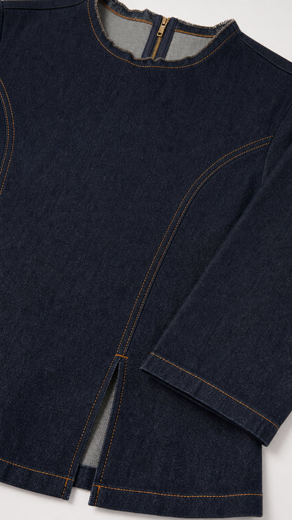 Close-up detail of Dark Blue denim top neckline, zipper, and contrast topstitching with front slit