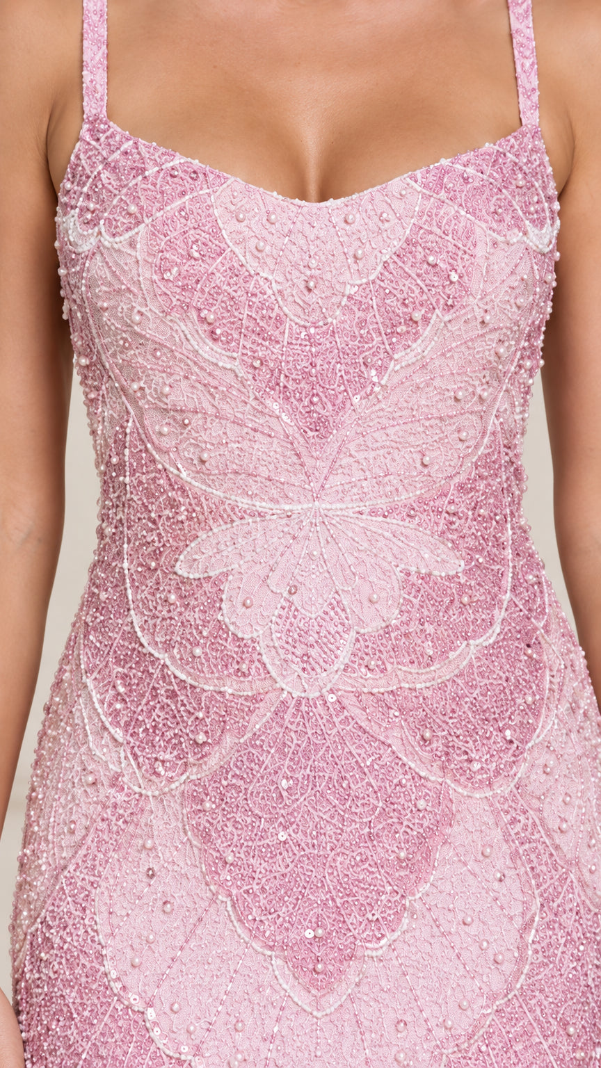 Close-up detail of intricate floral beadwork on blush pink lace dress