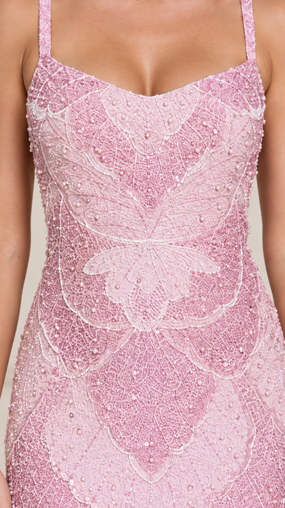 Close-up detail of intricate floral beadwork on blush pink lace dress