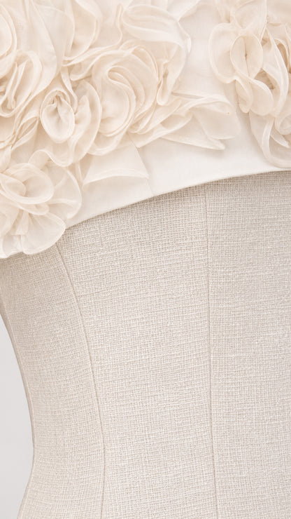 Close-up detail of 3D fabric rosettes on white dress bodice