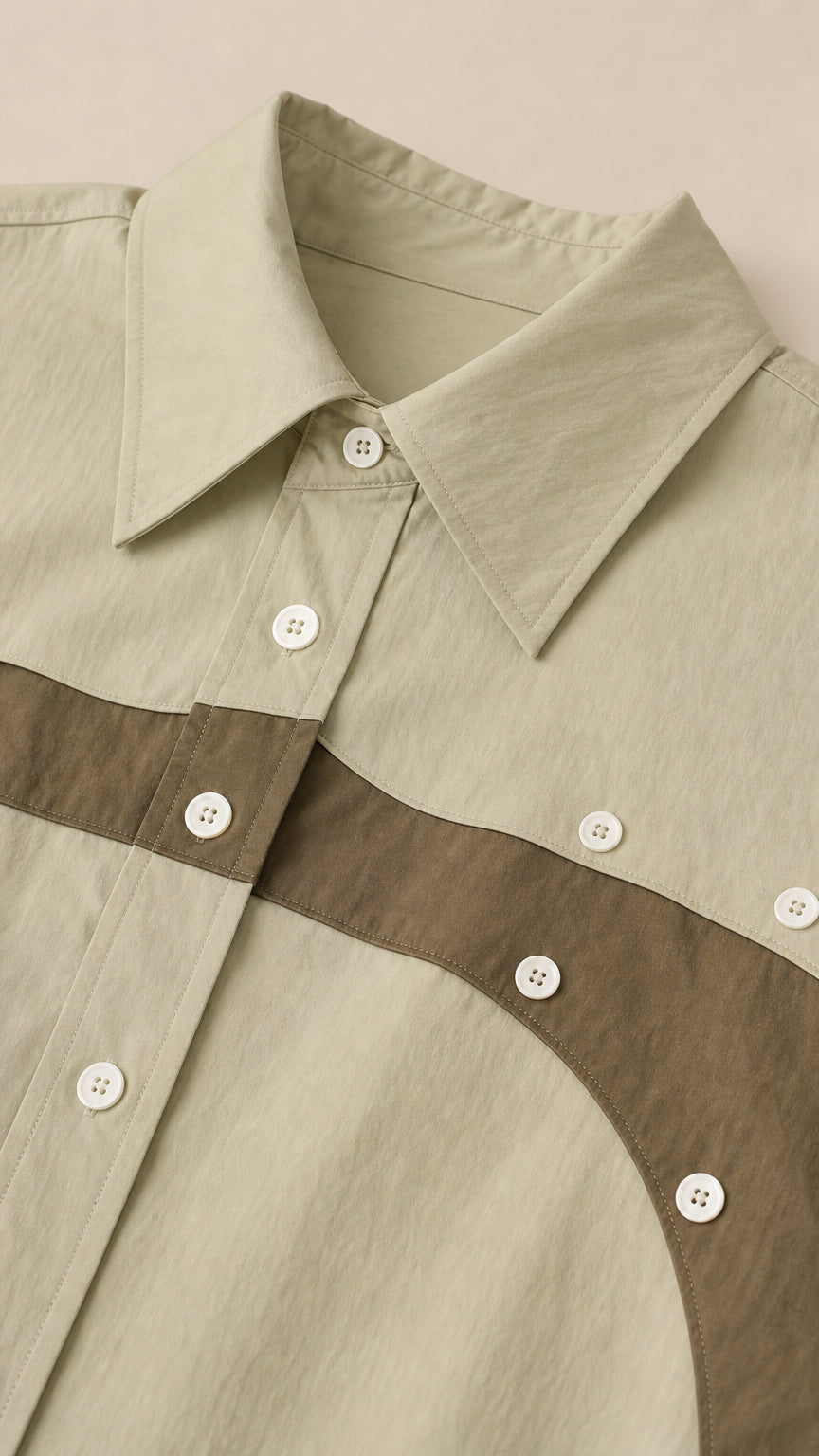 Close-up of point collar and button-down placket on sage green colorblock dress