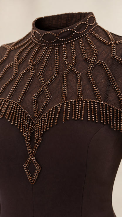 Close-up detail of geometric beadwork on sheer mesh high collar neckline