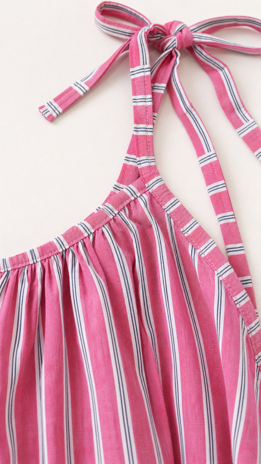 Close-up detail of self-tie shoulder straps and gathered neckline