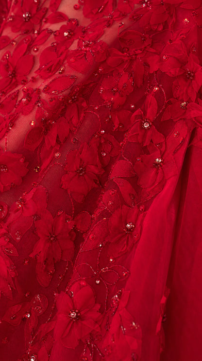 Close-up of red floral sequin and bead embroidery fabric