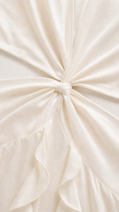 Close-up detail of knot waist cutout and ruffled fabric