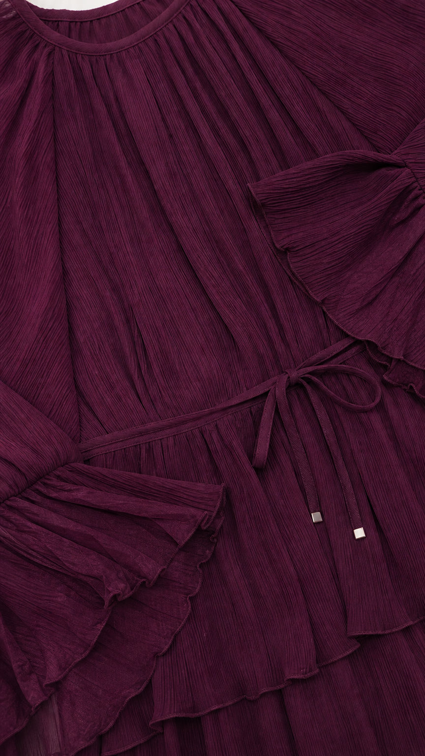 Close up of textured crinkle plissé fabric with ruffled tiers and drawstring waist detail