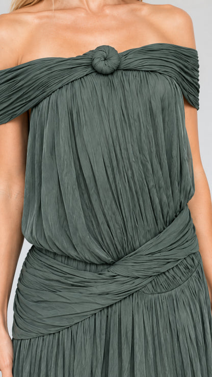 Close-up detail of textured pleating, neckline knot, and draped waist sash
