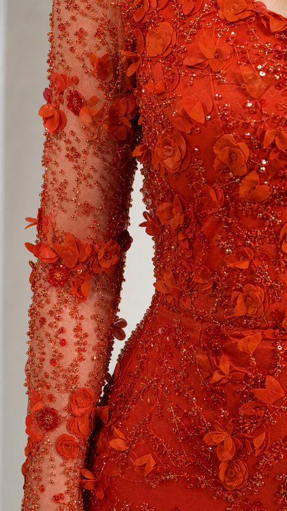 Close-up detail of 3D floral appliqués and beading on sheer mesh sleeve