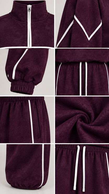 Detail close-up of zipper, contrast piping, drawstring waistband, and textured fabric