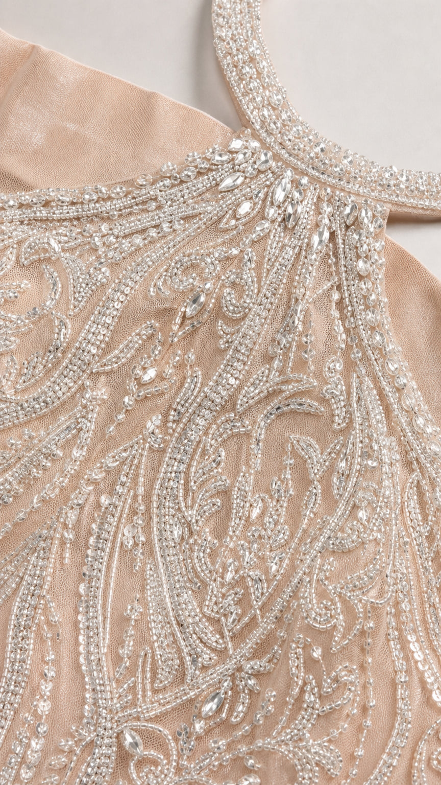 Close-up detail of intricate silver beadwork and sequin embellishments on mesh
