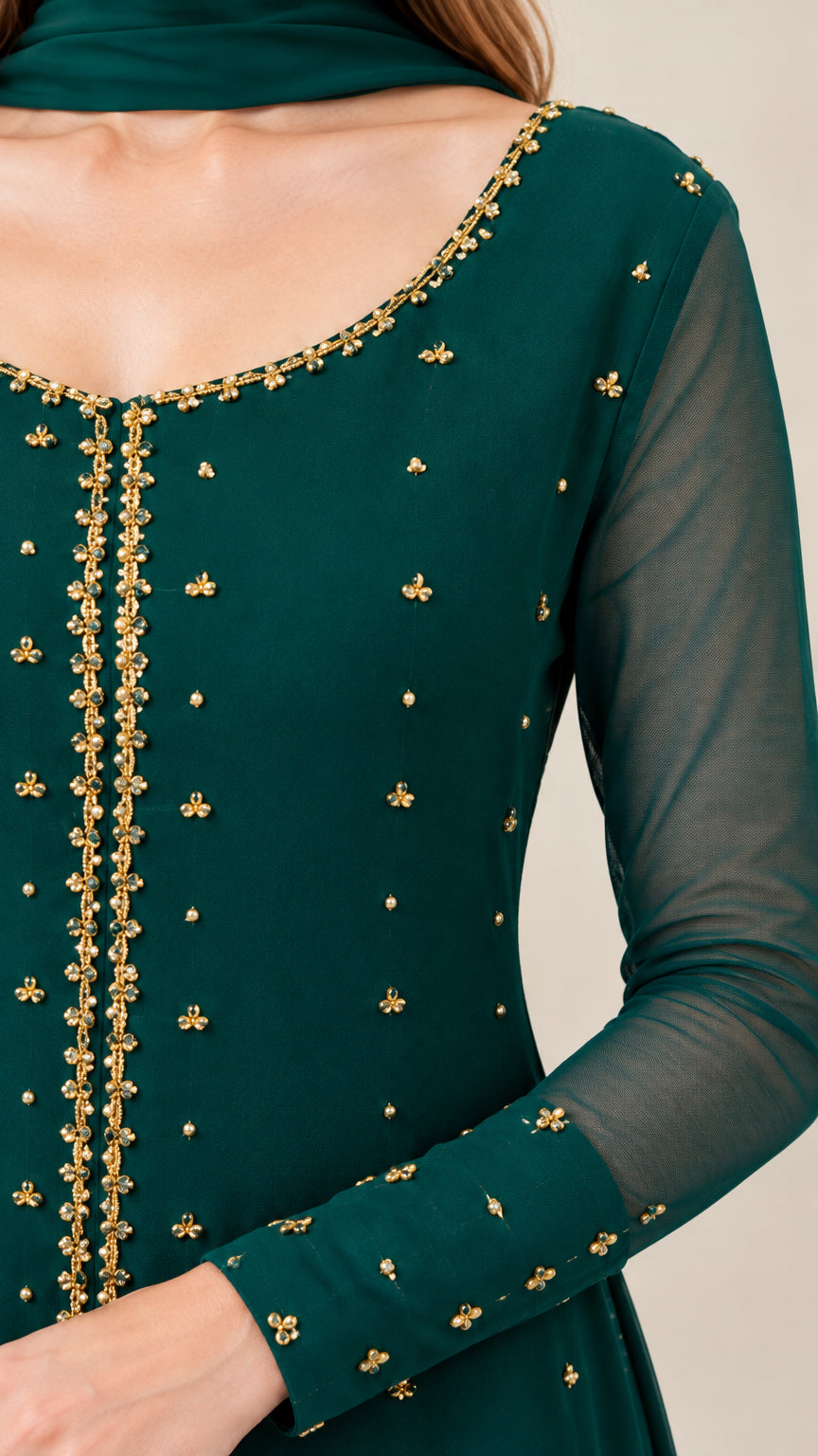 Close-up of gold-tone beaded scoop neckline and sheer sleeve detail
