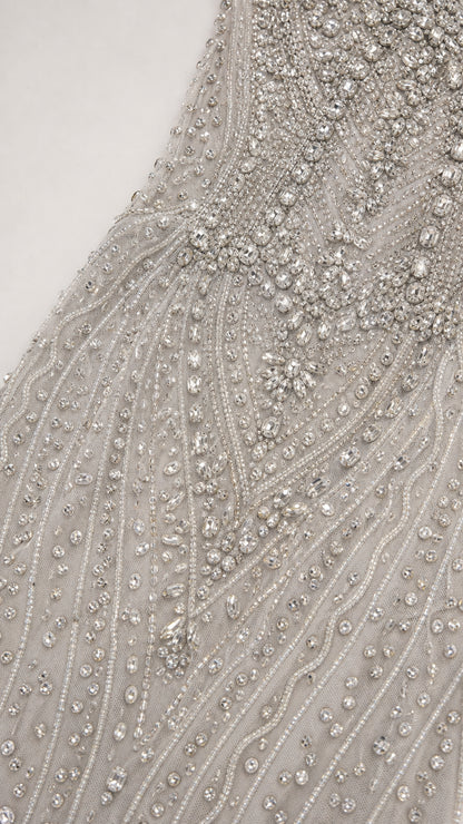 Close-up detail of intricate silver beadwork and crystal embellishments
